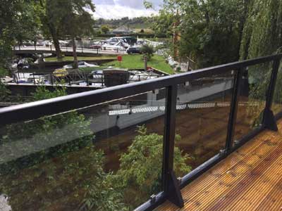 Glass balustrades on a balcony overlooking the river